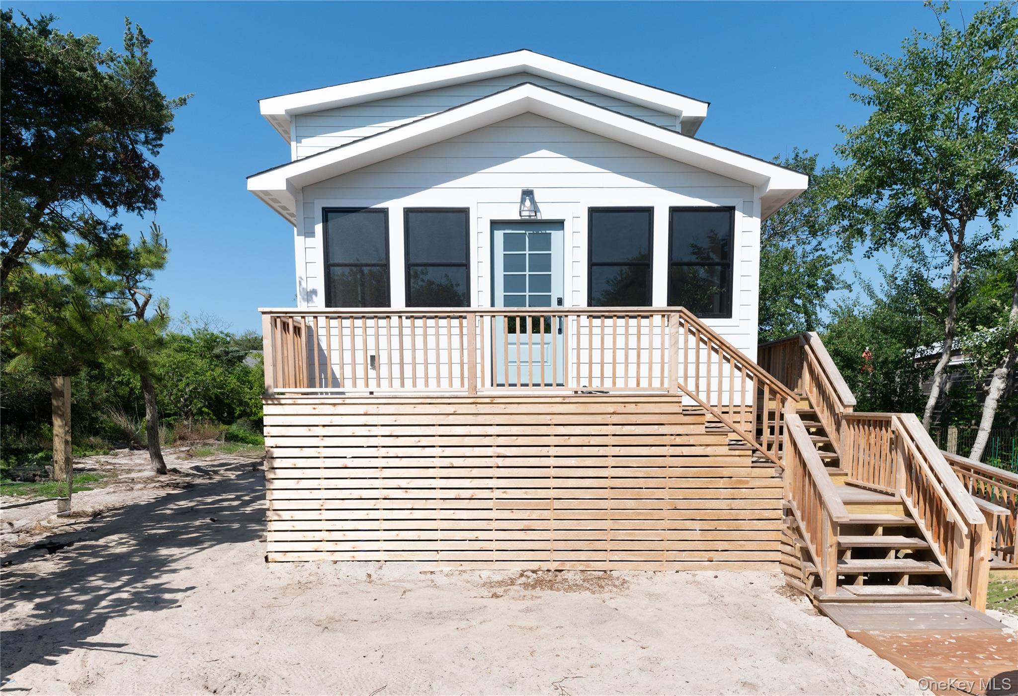 108 Ocean Road Ocean Beach, NY 11770 - Photo 2 of 23 View of front of home featuring stairway and a wooden deck