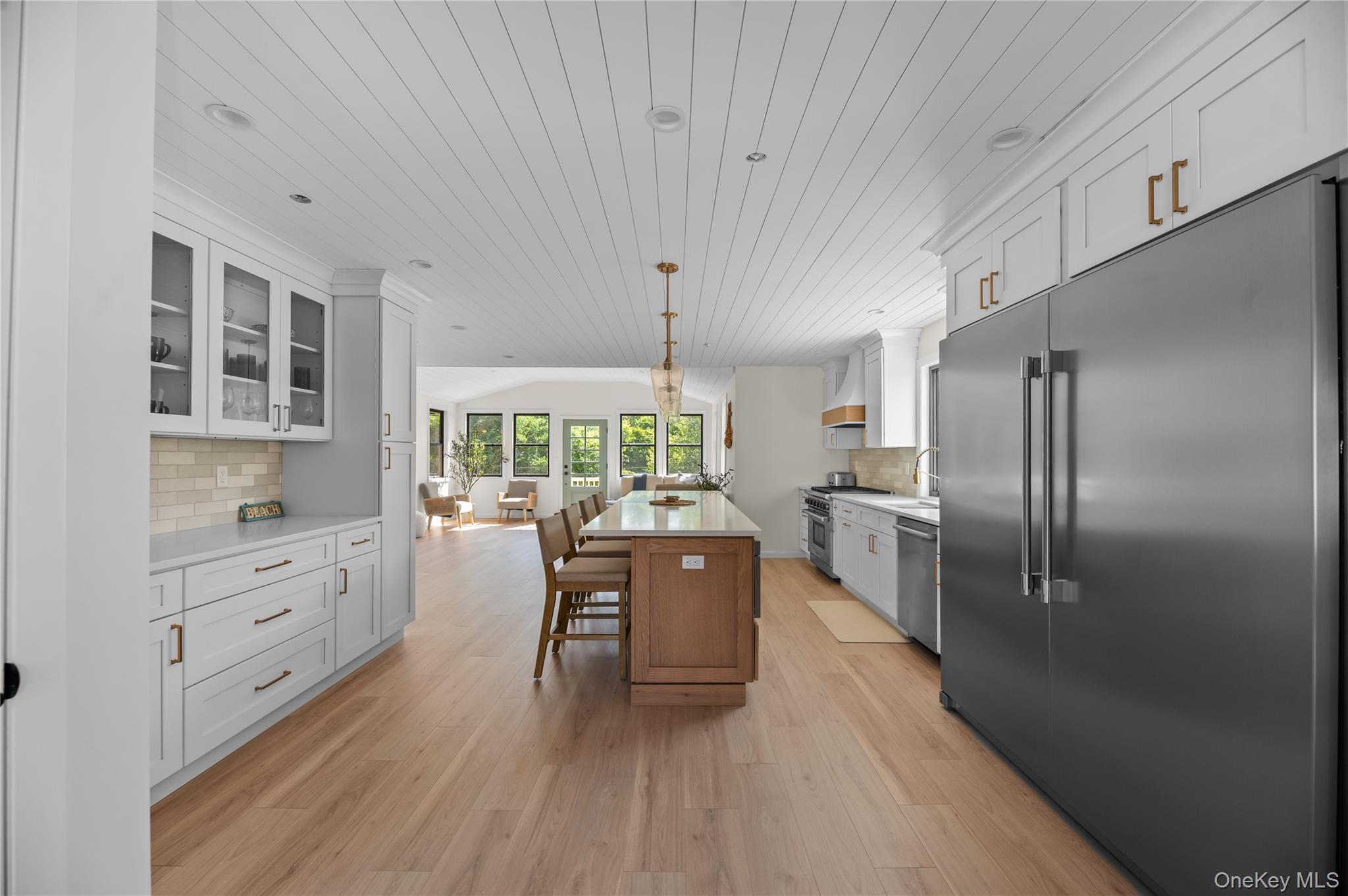 108 Ocean Road Ocean Beach, NY 11770 - Photo 23 of 23 Kitchen with backsplash, premium appliances, wooden ceiling, glass insert cabinets, and open floor plan
