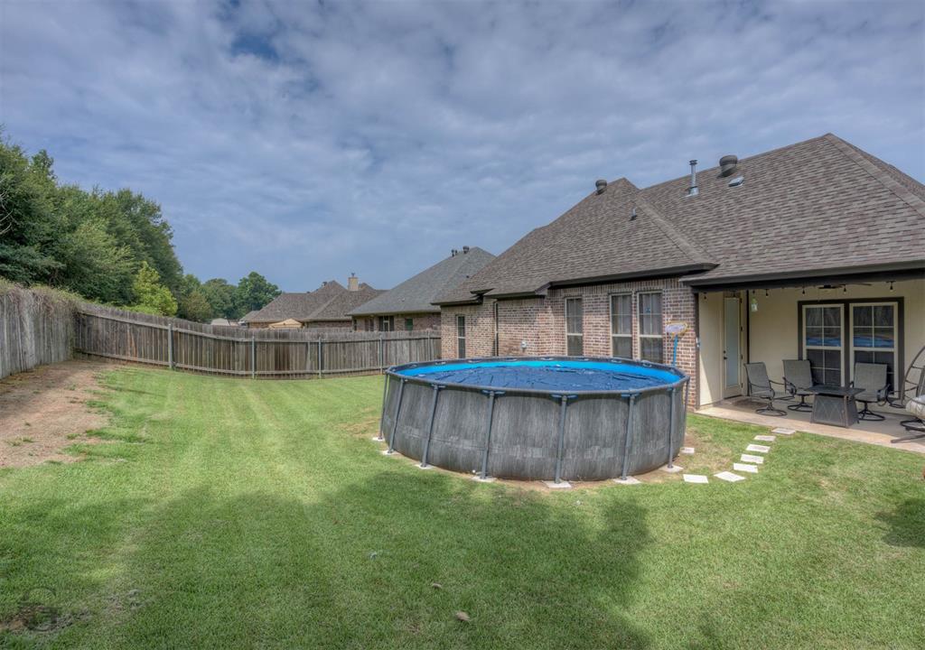 334 Wood Springs Haughton, LA 71037 - Photo 21 of 25 a view of a house with a backyard and tub