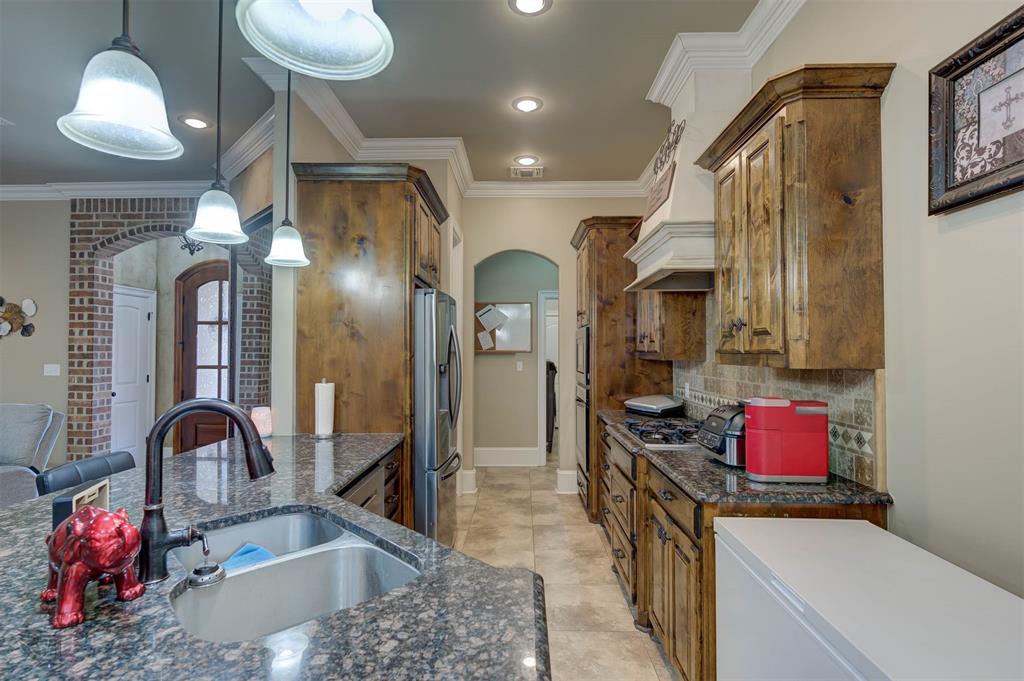 334 Wood Springs Haughton, LA 71037 - Photo 3 of 25 a kitchen with stainless steel appliances granite countertop a sink cabinets and wooden floor