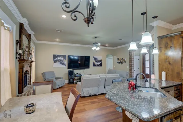 a living room with furniture a dining table and a fireplace