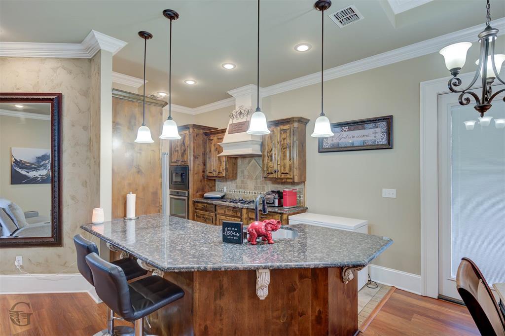 334 Wood Springs Haughton, LA 71037 - Photo 7 of 25 a kitchen with stainless steel appliances granite countertop a kitchen island a refrigerator and a table