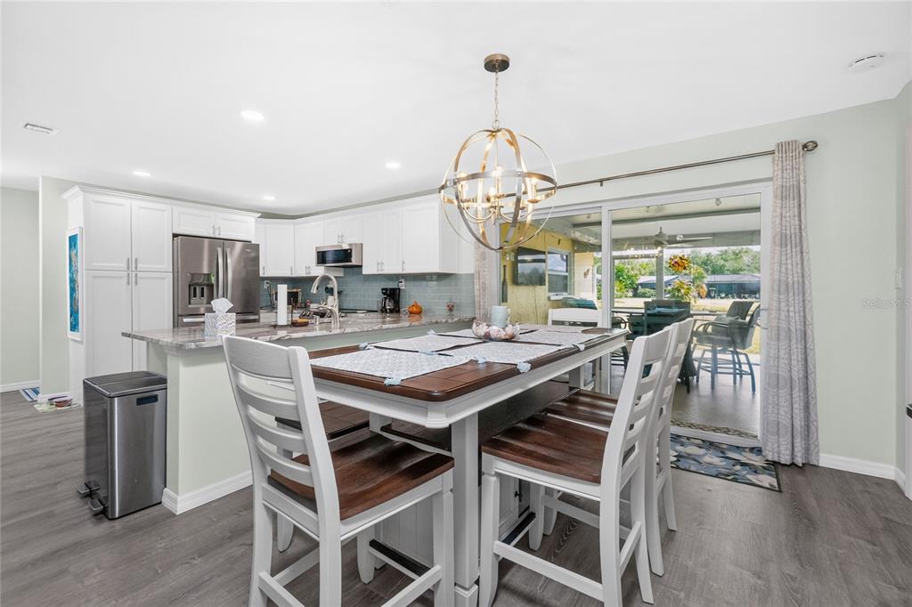 219 Caddy Road Rotonda West, FL 33947 - Photo 25 of 89 a view of a dining room with furniture window and wooden floor