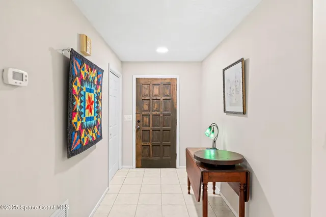 a living room with furniture a flat screen tv and a window