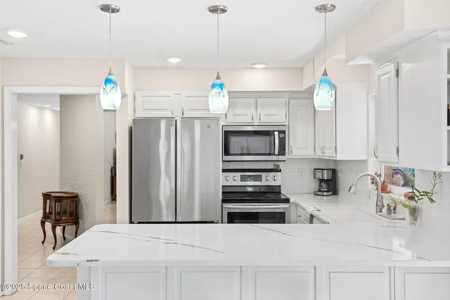 a kitchen with a sink and chairs