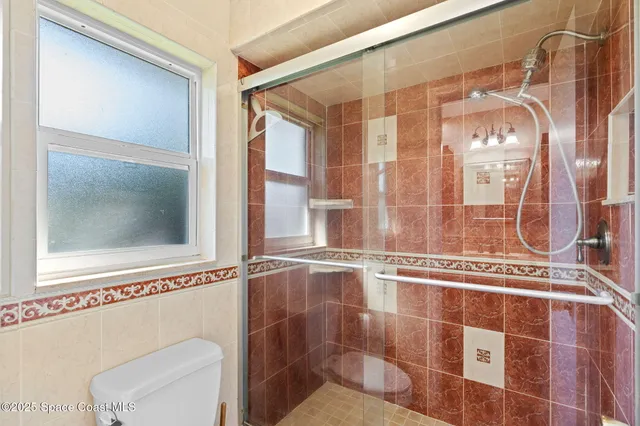 a bathroom with a sink a mirror and a shower