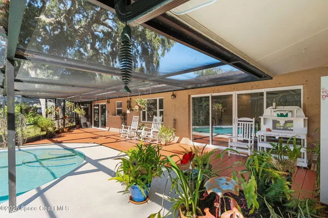 a view of a swimming pool with a patio and a yard