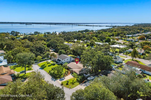 an aerial view of a houses with a yard