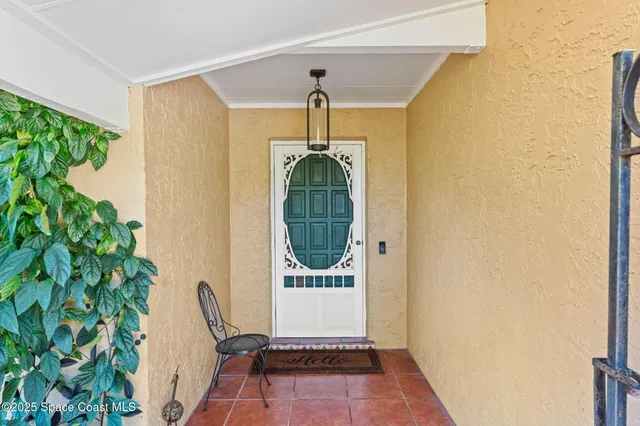 a living room with furniture and painting on the wall