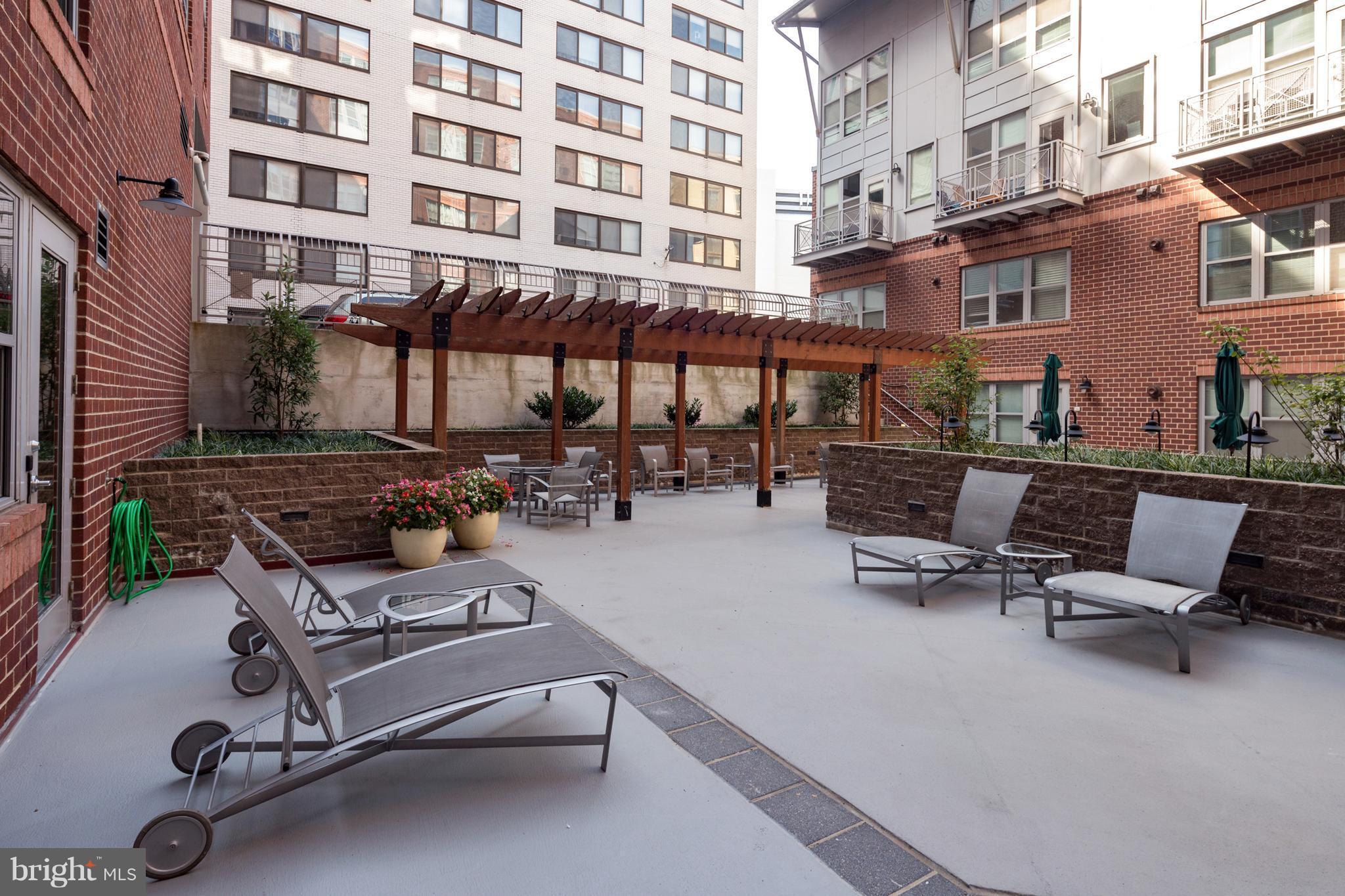 1300 N Street Northwest, Unit 4 Washington, DC 20005 - Photo 16 of 19 a view of a patio with couple of chairs in front of building
