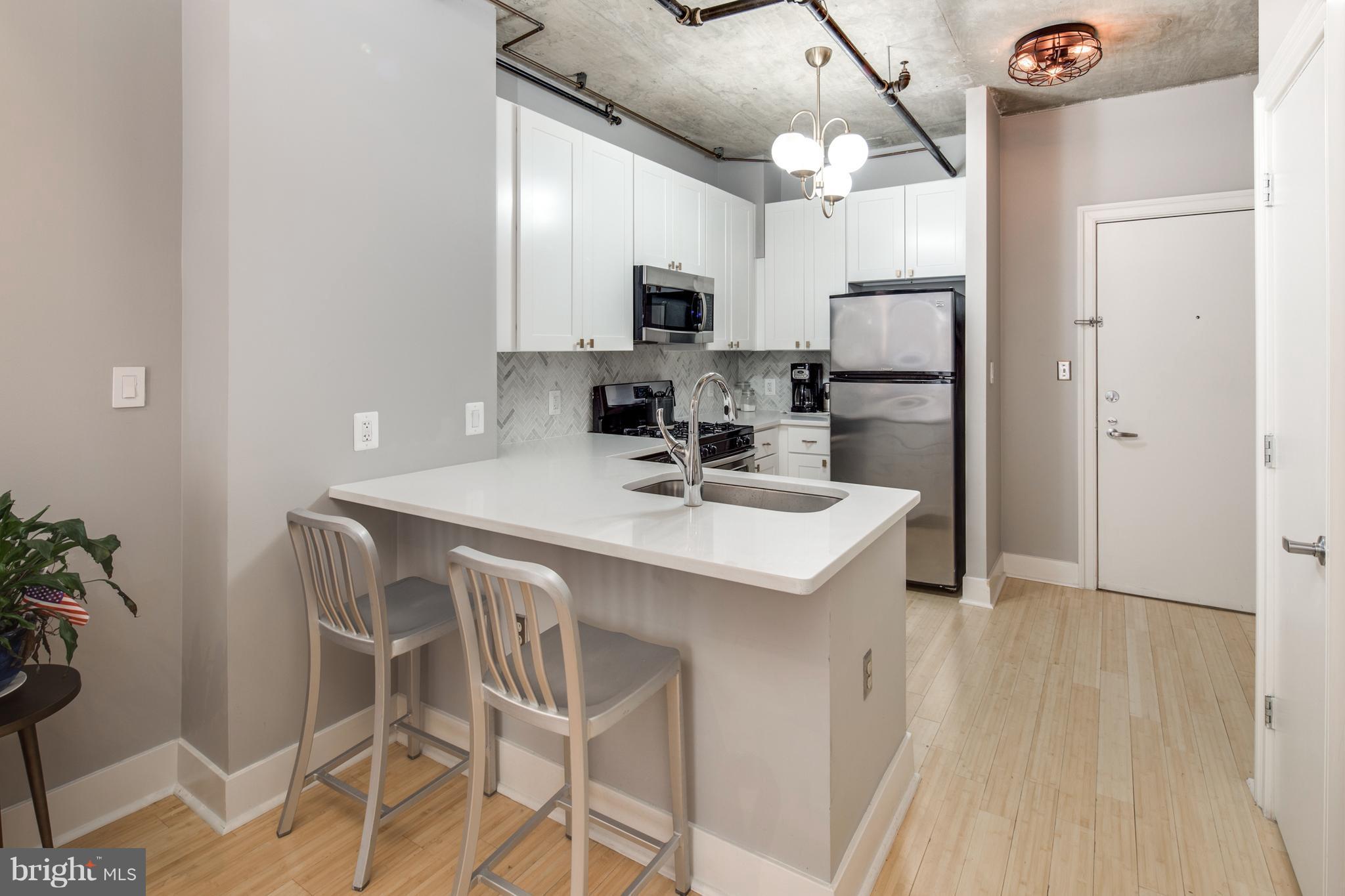 1300 N Street Northwest, Unit 4 Washington, DC 20005 - Photo 6 of 19 a kitchen with a sink cabinets and microwave