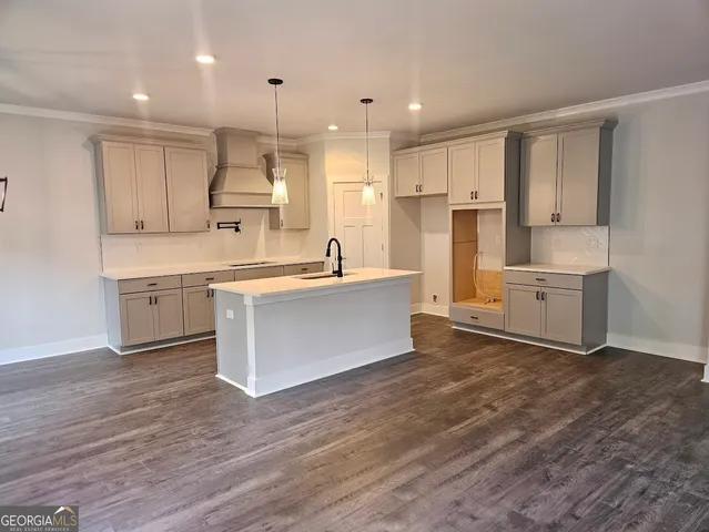 a large kitchen with cabinets and wooden floor