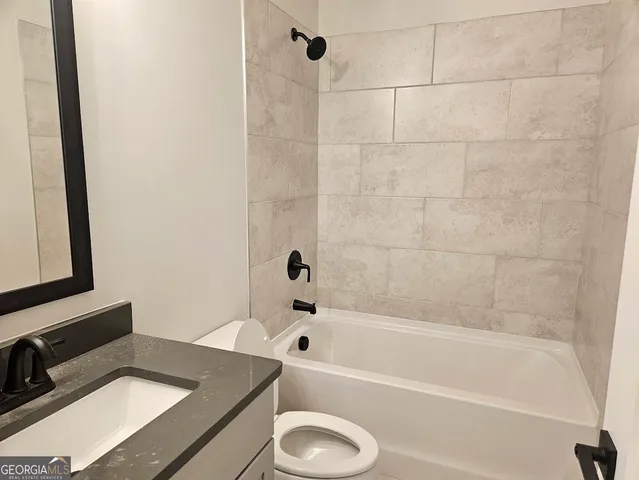 a bathroom with a tub sink and vanity