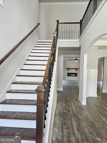 a view of staircase with white walls and a window