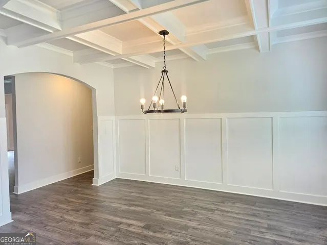 a view of a room with wooden floor and a window