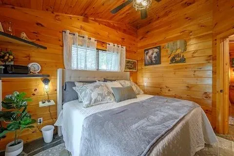 a bed room with a bed and a large window