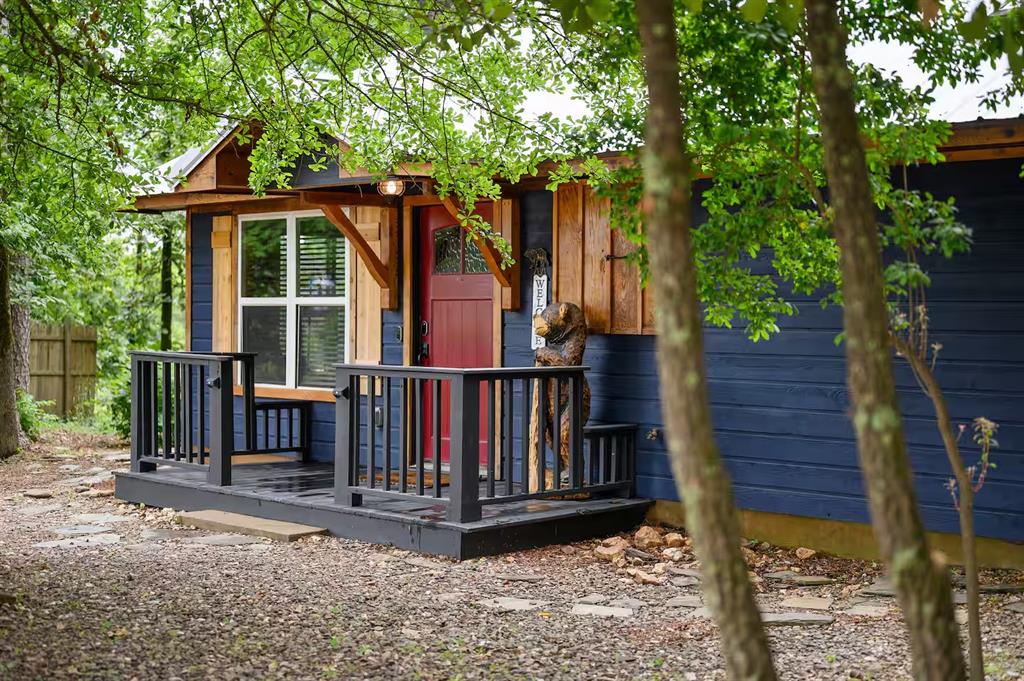 209 Pinyon Road Broken Bow, OK 74728 - Photo 3 of 31 a view of a house with a small yard and wooden floor
