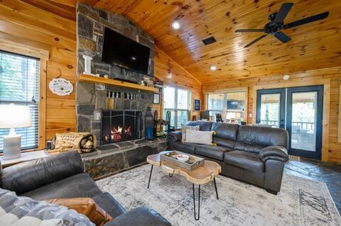 209 Pinyon Road Broken Bow, OK 74728 - Photo 6 of 31 a living room with furniture a flat screen tv and a fireplace