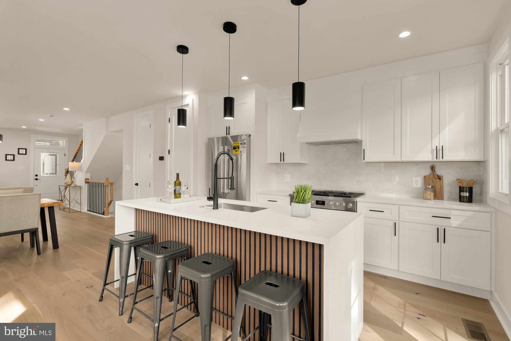 5331 42nd Street Northwest Washington, DC 20015 - Photo 14 of 51 a kitchen with stainless steel appliances kitchen island granite countertop a sink a stove a dining table and chairs