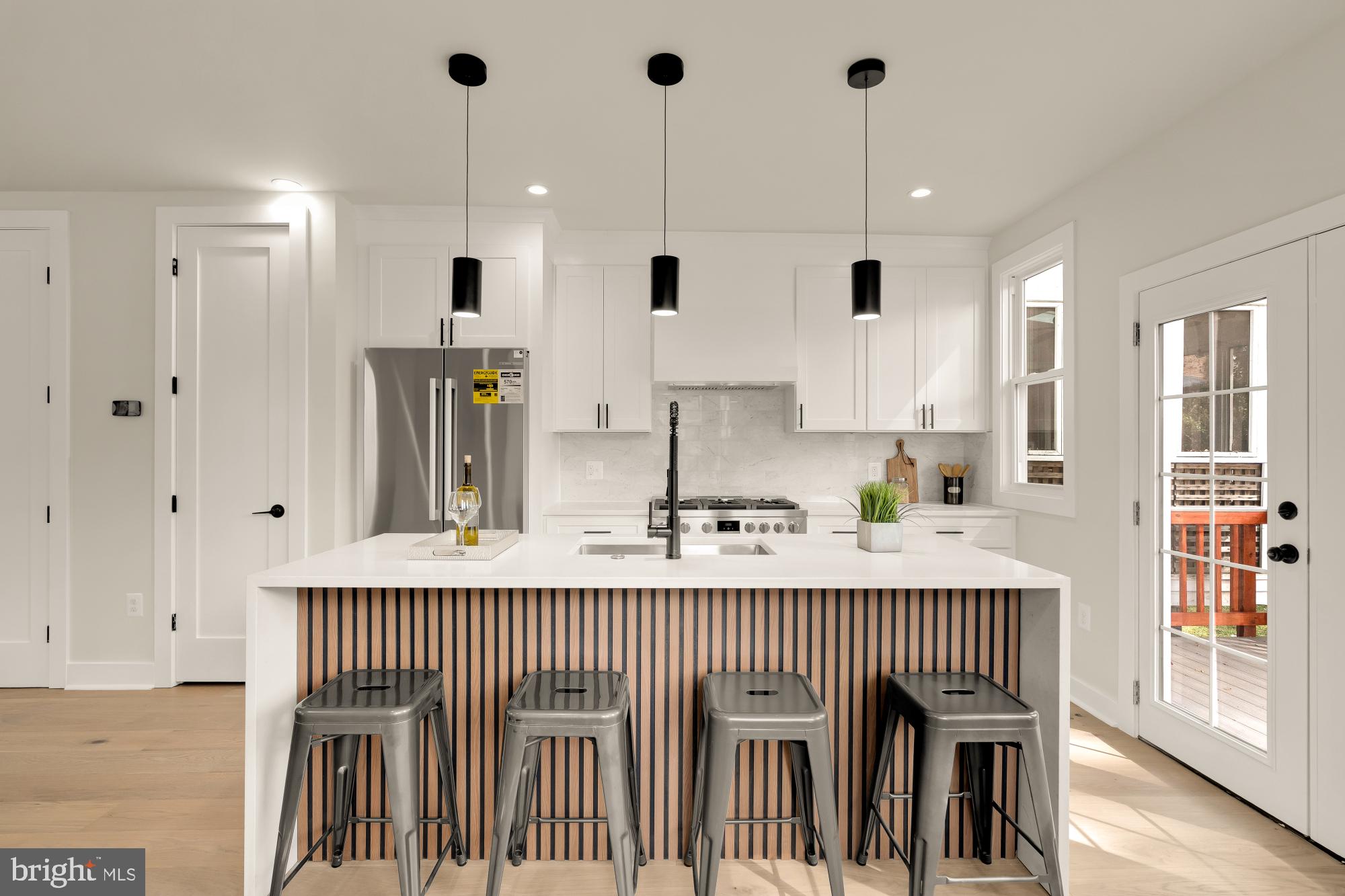 5331 42nd Street Northwest Washington, DC 20015 - Photo 15 of 51 a kitchen with stainless steel appliances granite countertop a stove a sink and a refrigerator