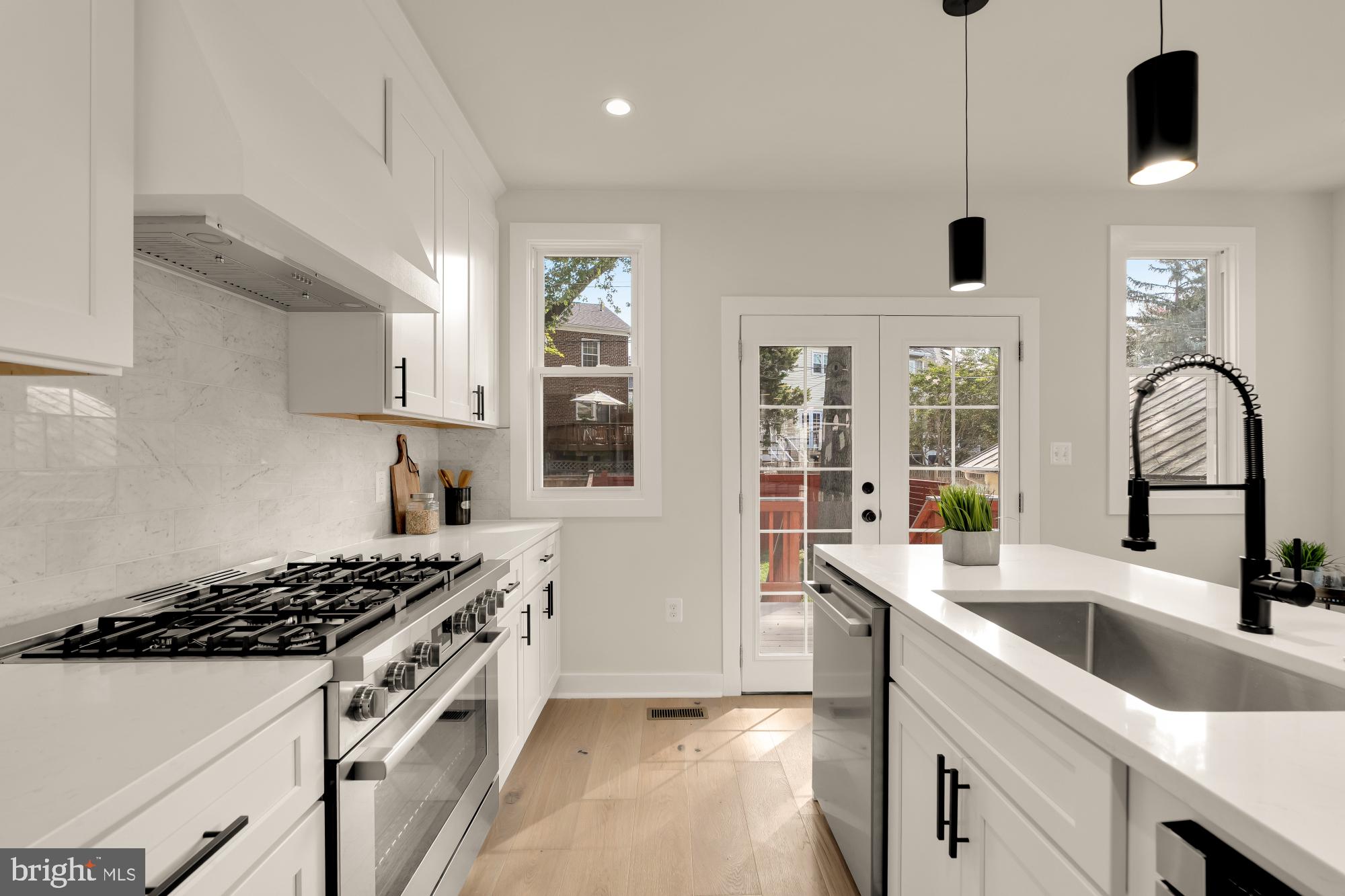 5331 42nd Street Northwest Washington, DC 20015 - Photo 17 of 51 a kitchen with stainless steel appliances granite countertop a sink stove and refrigerator