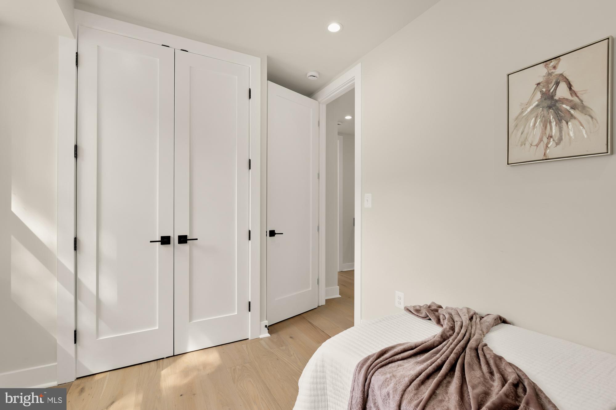 5331 42nd Street Northwest Washington, DC 20015 - Photo 37 of 51 a bedroom with a bed and a painting on the wall