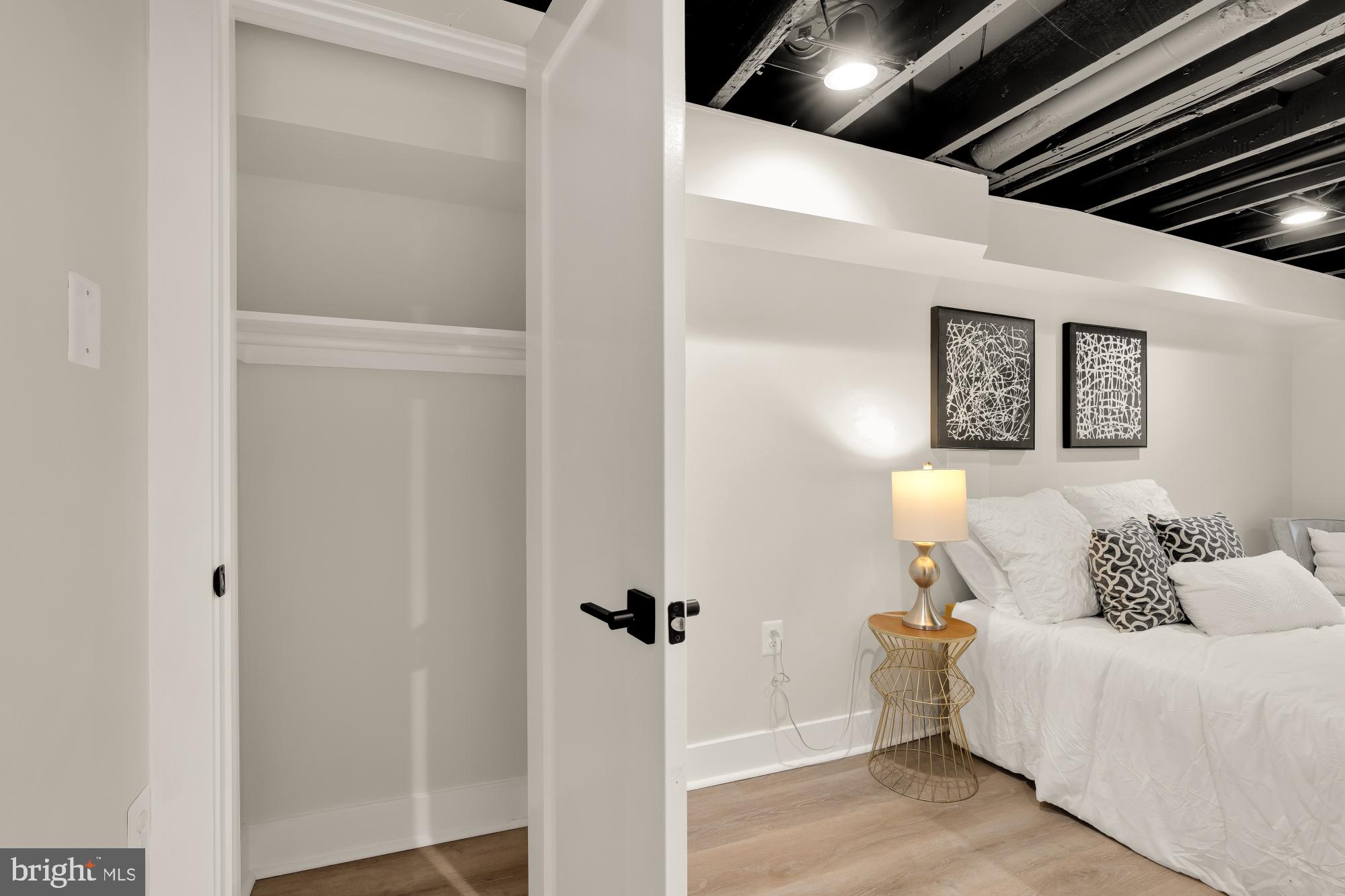 5331 42nd Street Northwest Washington, DC 20015 - Photo 45 of 51 a bed room with a bed and a painting on the wall