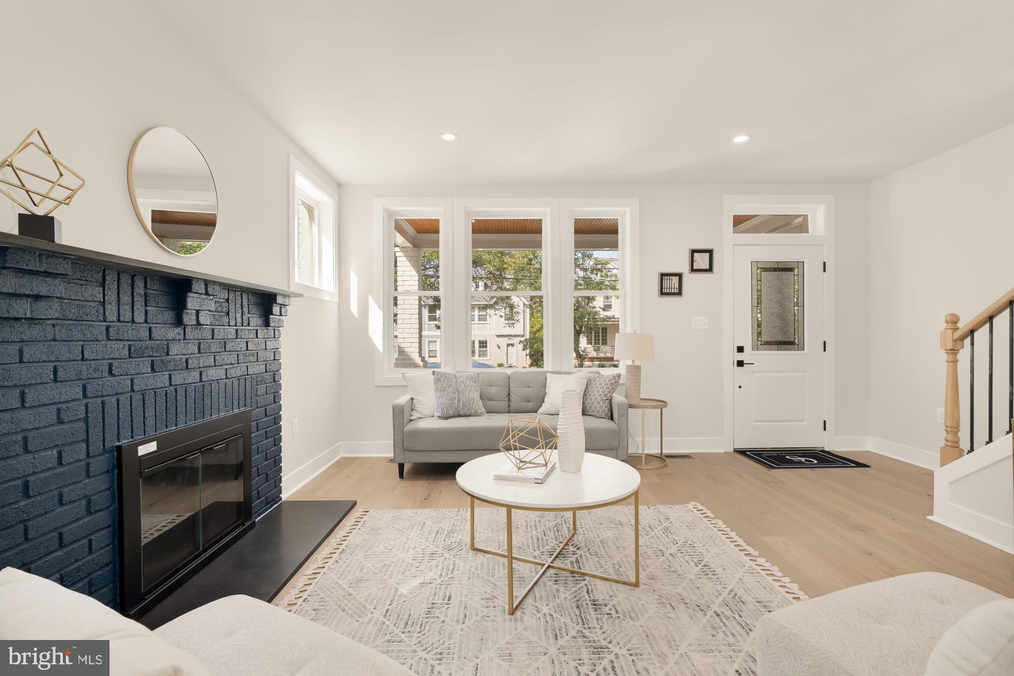 5331 42nd Street Northwest Washington, DC 20015 - Photo 9 of 51 a living room with furniture a table and a fireplace