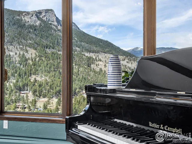 a dining room with furniture a chandelier and wooden floor