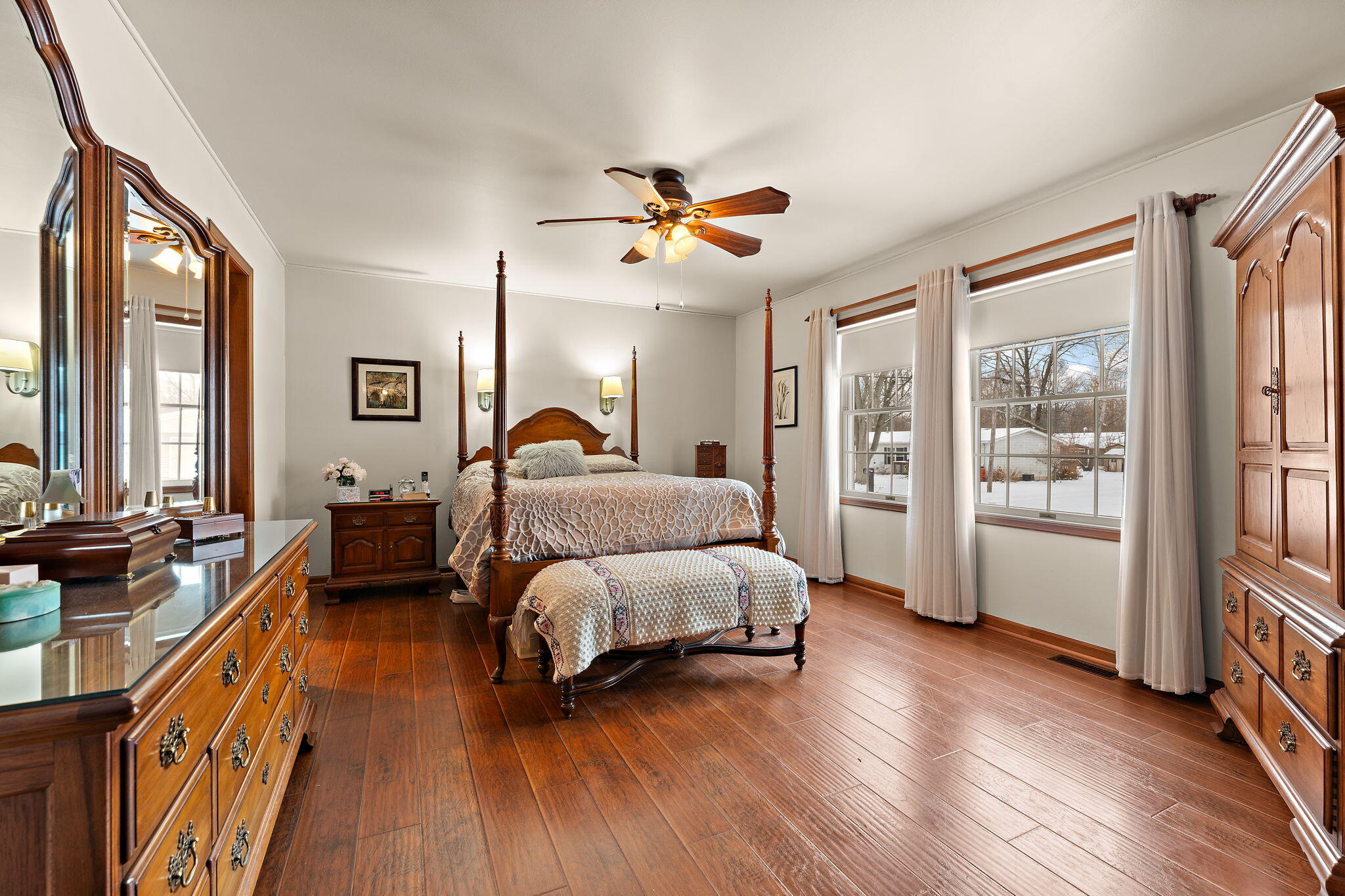 507 South 20th Street Chesterton, IN 46304 - Photo 15 of 27 a spacious bedroom with a bed and a chandelier