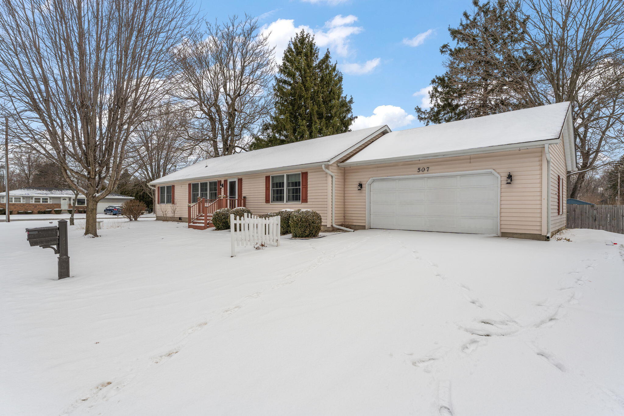 507 South 20th Street Chesterton, IN 46304 - Photo 26 of 27 a view of a white house with a yard covered in snow