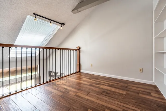 wooden floor in a hall with a window
