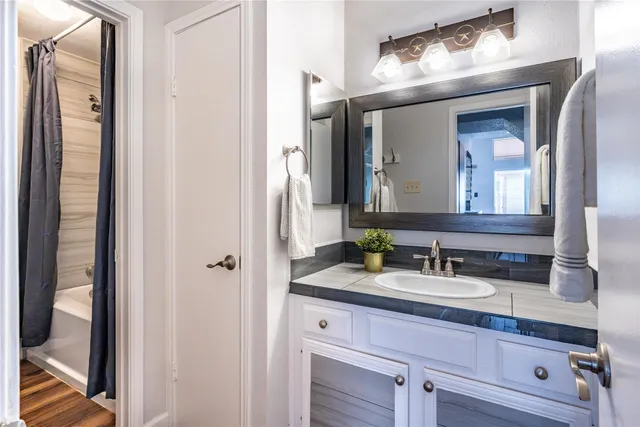 a bathroom with a double vanity sink and a mirror