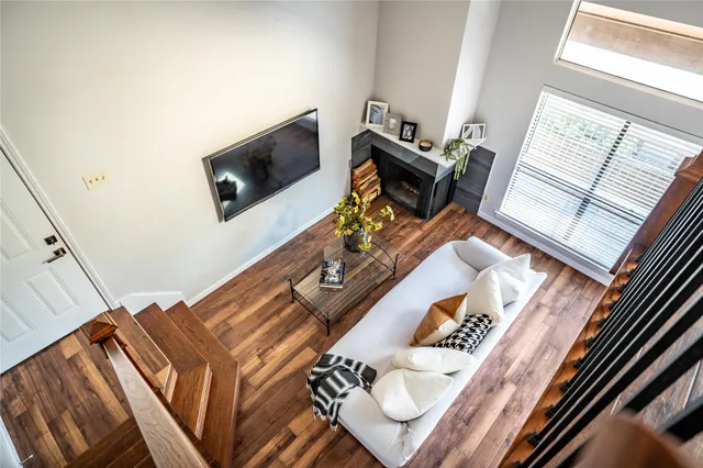 a living room with a bed furniture and a flat screen tv
