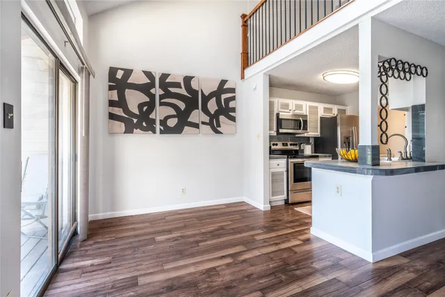 a kitchen with a refrigerator and a stove