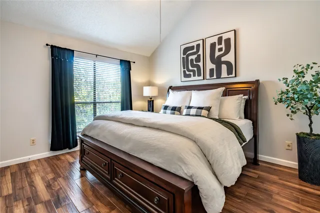 a bed sitting in a bedroom next to a window