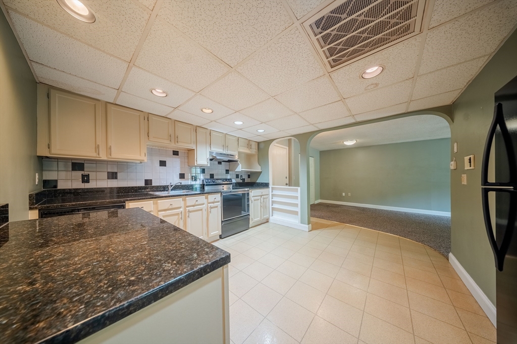 3 Shadowbrook Lane, Unit 3 Milford, MA 01757 - Photo 11 of 35 a kitchen with stainless steel appliances granite countertop a sink stove and refrigerator