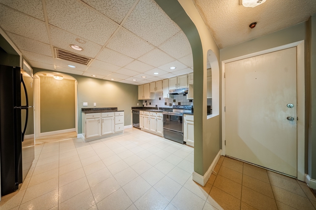 3 Shadowbrook Lane, Unit 3 Milford, MA 01757 - Photo 13 of 35 a large kitchen with cabinets and stainless steel appliances