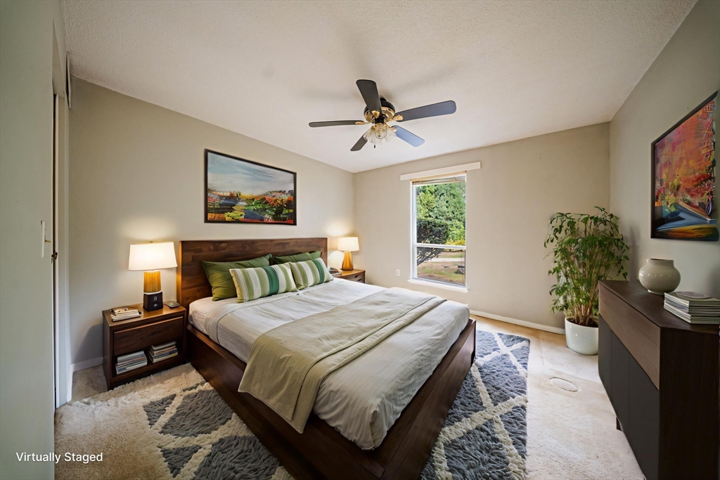 3 Shadowbrook Lane, Unit 3 Milford, MA 01757 - Photo 16 of 35 a bedroom with a bed a bookshelf and a potted plant