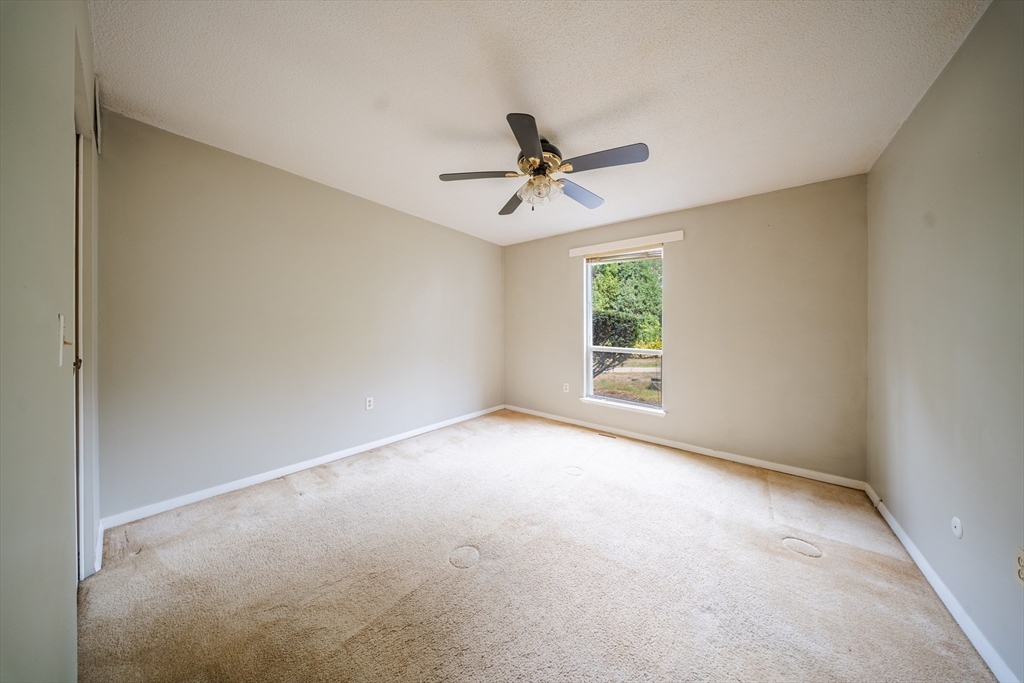 3 Shadowbrook Lane, Unit 3 Milford, MA 01757 - Photo 17 of 35 an empty room with windows and fan