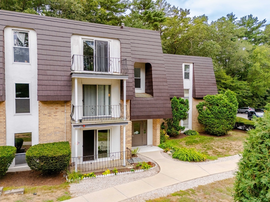3 Shadowbrook Lane, Unit 3 Milford, MA 01757 - Photo 2 of 35 a view of a brick house with plants and large tree