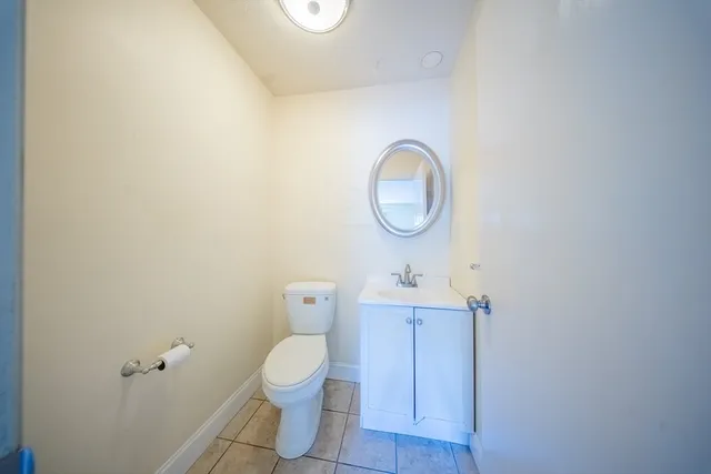 a front view of a house with a garden and plants