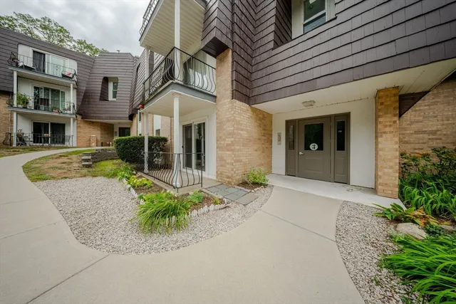 an aerial view of a house with a garden and swimming pool
