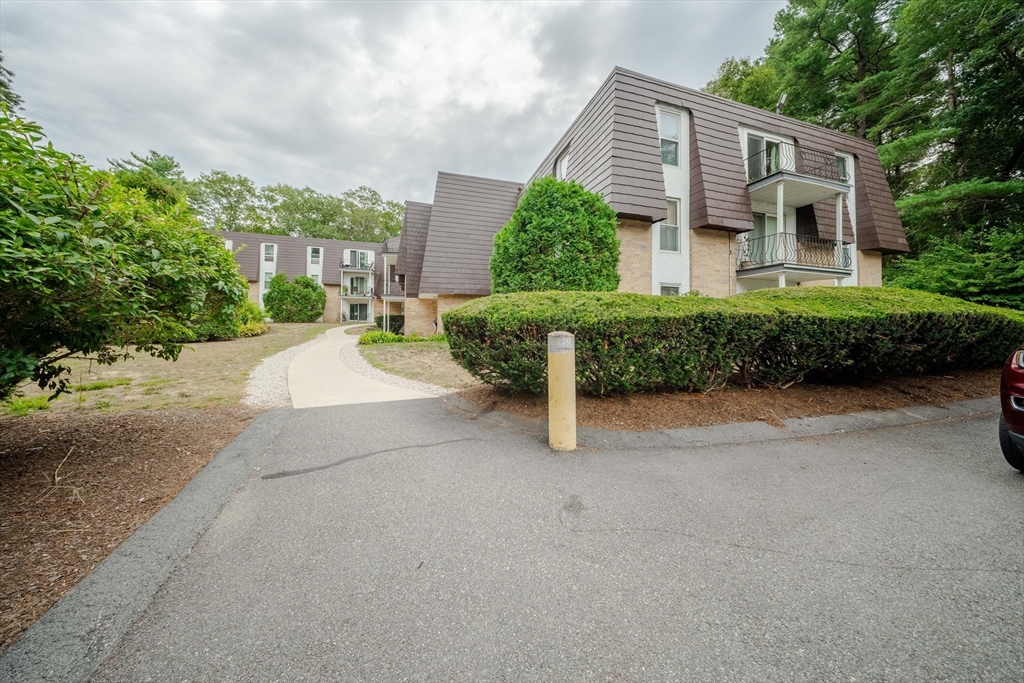 3 Shadowbrook Lane, Unit 3 Milford, MA 01757 - Photo 35 of 35 a front view of a house with a yard and potted plants