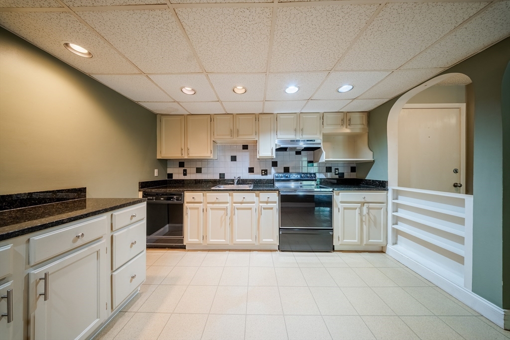 3 Shadowbrook Lane, Unit 3 Milford, MA 01757 - Photo 10 of 35 a kitchen with granite countertop white cabinets and stainless steel appliances
