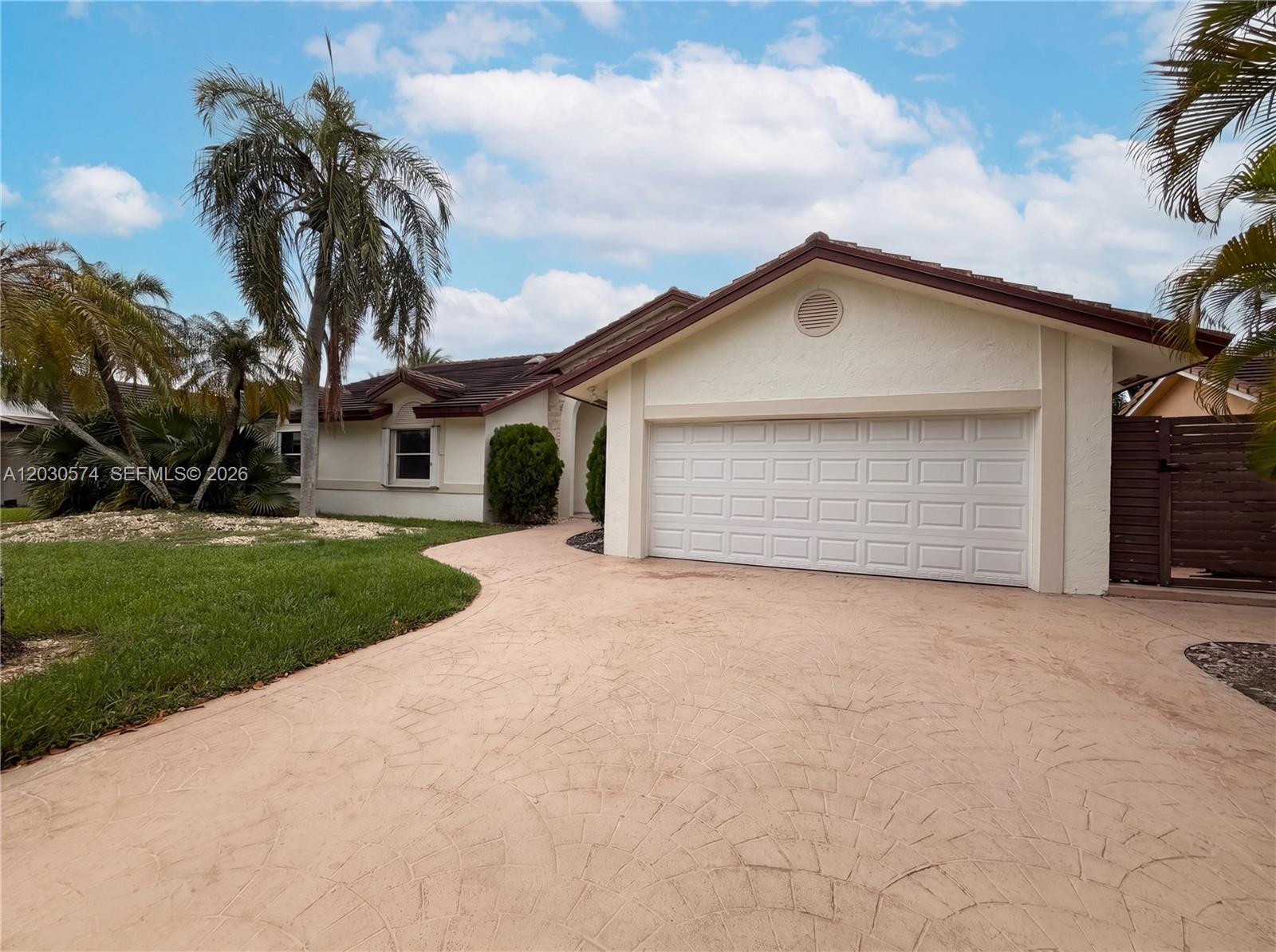 16571 Southwest 145th Avenue Miami, FL 33177 - Photo 22 of 25 a front view of a house with a yard and garage