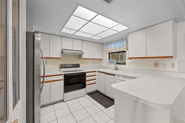 a kitchen with cabinets and stainless steel appliances