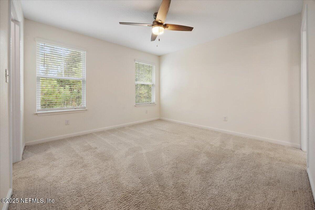 54 Ridge Lake Rd Street St. Augustine, FL 32086 - Photo 12 of 25 an empty room with windows and fan