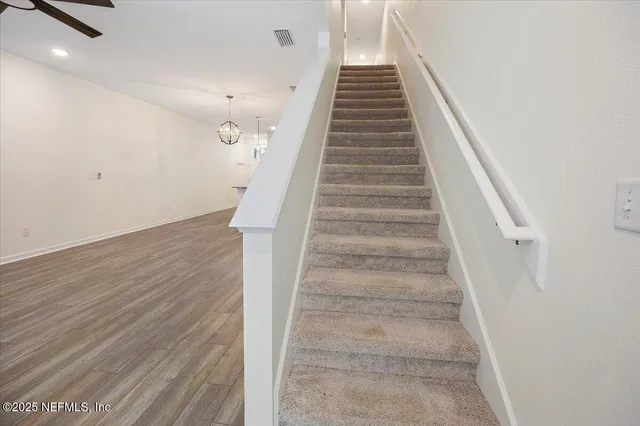 a bedroom with a bed and ceiling lamp