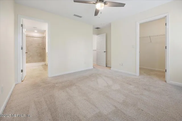 a bathroom with a double vanity sink a toilet a mirror and shower